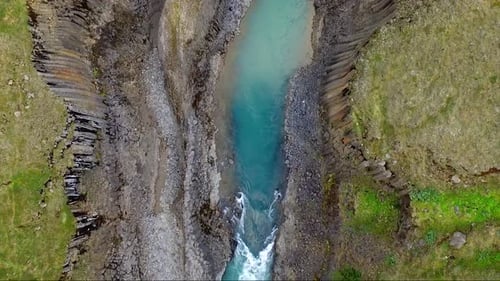 Aerial, top down, drone shot over the basalt columns and the Studlagil Canyon, sunny day, in Eastern