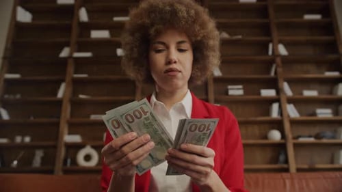 Successful Woman Counting Stacks of Cash
