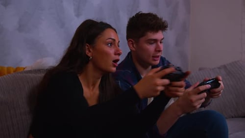Couple Playing Video Games on the Couch