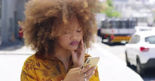 4k video footage of an attractive young woman receiving bad news via text while out in the city