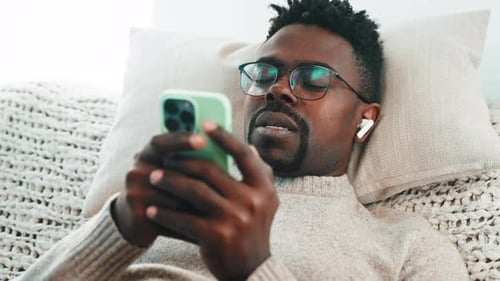 Man Relaxing and Looking at Phone