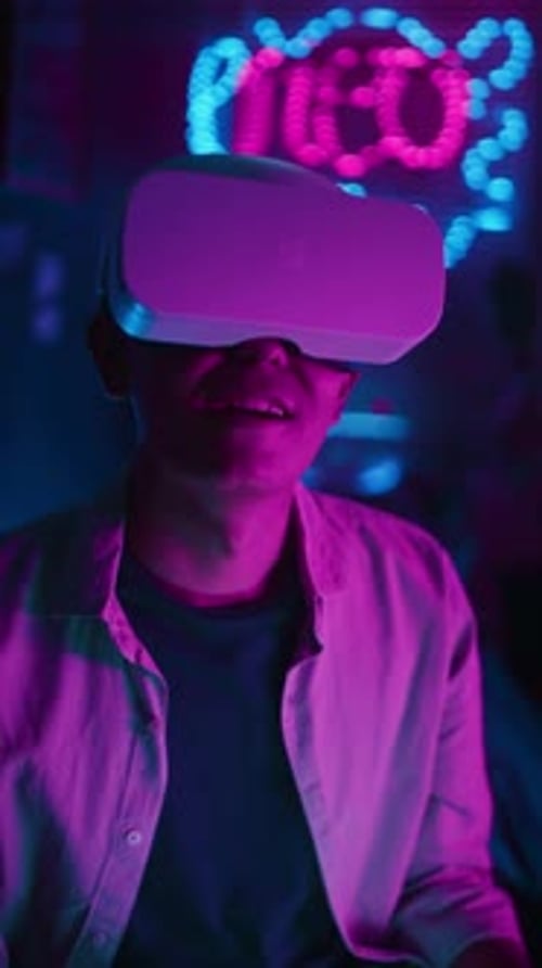 Person Wearing Virtual Reality Headset in Neon Room