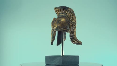A rotating close up shot of a spartan warrior ancient greek metal bronze helmet, with shapes and for