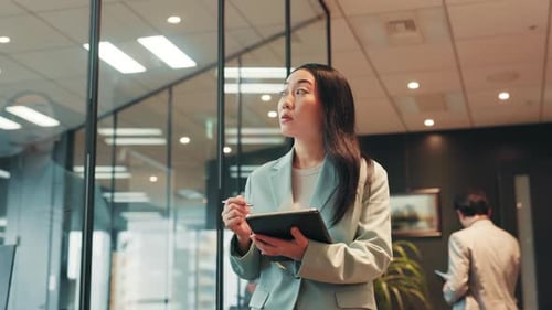 Japanese woman, tablet and walking in office for communication, reading and agenda for business