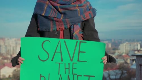 Close Up Hands Man Activist with Save the Planet Ecology Poster Background View of City Nature Earth