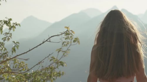 Woman Enjoying Mountain View on Sunny Day