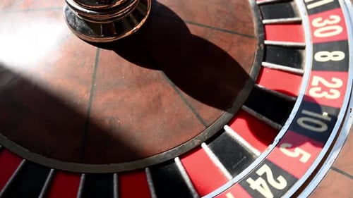 A Closeup of a Vintage Roulette Wheel Spinning in a Casino Sunbeams Illuminate the Scene