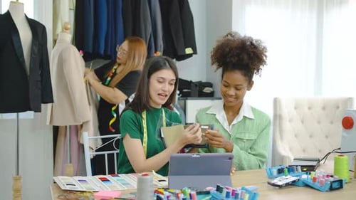 Young two fashion designers use tablet meeting with graphic designer discuss show dress design