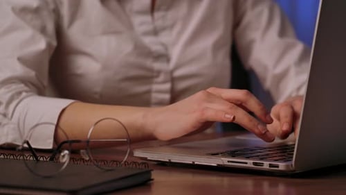 Close Up of Hands Typing on Laptop Keyboard