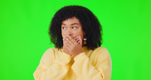 Shock, wtf and face with a woman on a green screen background in studio covering her mouth