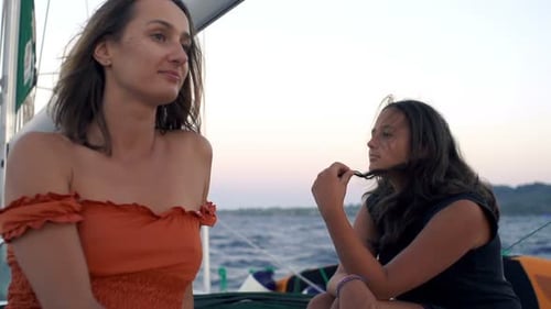 Mother and daughter relaxing and smiling sailing on a yacht in Greece super slow motion