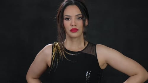 An Elegant Portrait Featuring a Confident Woman Gracefully Dressed in a Beautiful Black Dress