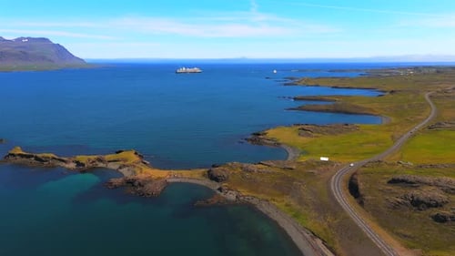 Marvel at the stunning contrasts in Djúpivogur’s landscape, where the mountains stand tall against a