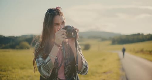 Young Woman Taking Photos in a Rural Setting