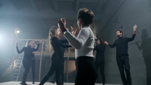 Theater Director Moving Hands Rehearsing Show with Actors and Actresses Walking on Backstage