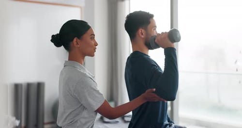 Physiotherapist Helping Man with Arm Exercises