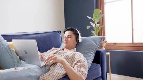 Young Adult Working on Laptop on Velvet Couch