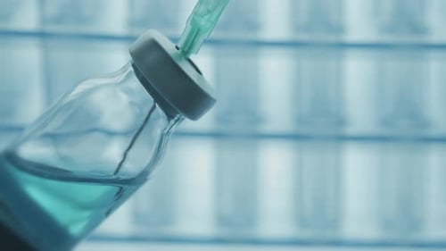 Syringe Needle Piercing Glass Vial With Liquid