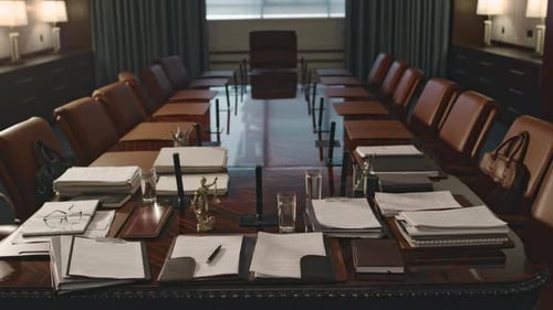 Empty Boardroom with Piles of Legal Documents on Wooden Conference Table