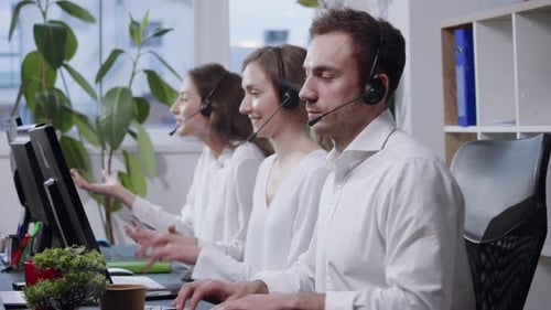 Side Close Up View of Crazy Team of Call Center Operators Acting Crazy with Headsets in Front of the