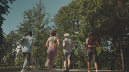 Young Active People Jogging Outdoors Back View