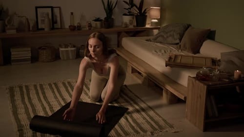 Yogini Spreading Mat on Floor before Home Practice