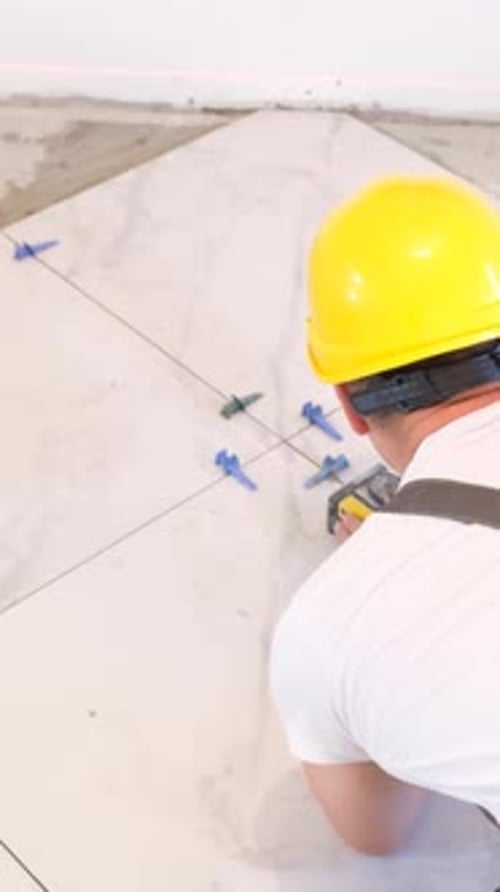 A Worker Laying Large Wideformat Floor Tiles Vertical Video