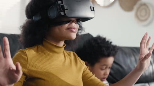 Woman Using VR Headset Next to Child on Couch