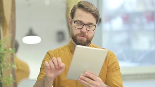 Man Using Tablet Device Indoors Close-Up