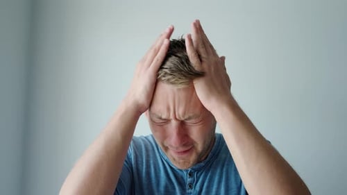 Handsome Caucasian Man with Hand on Head Suffering From Headache Because Stress and Pain Male with