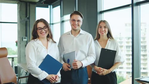 Professionals Engaged in Teamwork Within a Bright Office Environment Showcasing Collaboration and