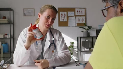 Woman Doctor Explains Medicine to Patient