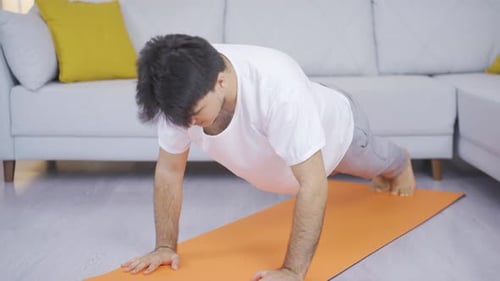 Man doing push-ups at home.