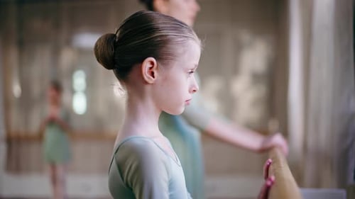 Close Up Professional Ballet School for Children Girls in Green Bodysuit with a Trainer Training at