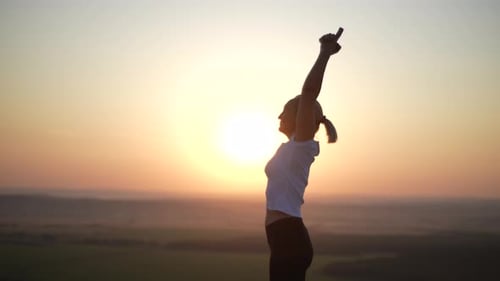 Side View of Unrecognizable Female Yogini Practicing Yoga Bending Backward and Finishing with