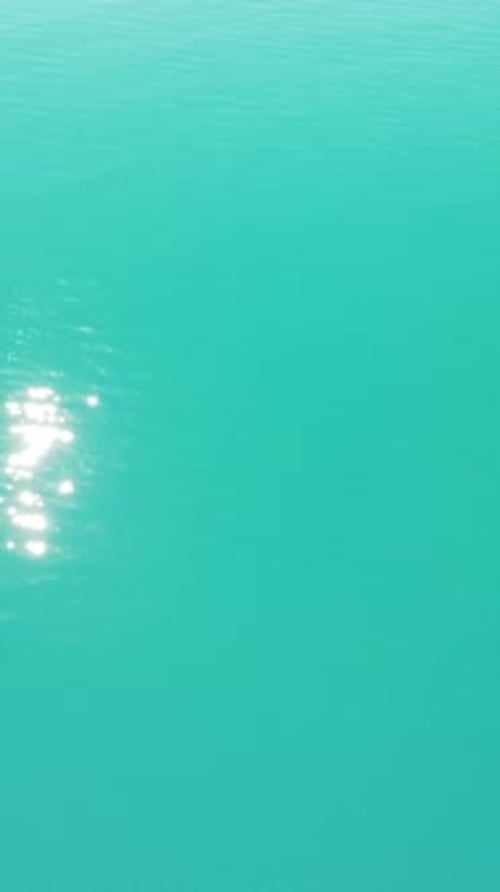 Abstract Aerial Calm Sea Summer Ocean Sunset Nature Small Waves on Water Surface with Clear Blue Sky