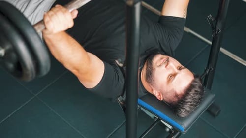 Doing bench press exercise in the gym