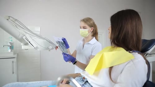 Dentist Consults Patient with X-Ray in Clinic