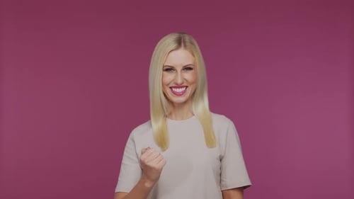 Young Beautiful Blond Girl in the Studio Portrait of Emotional Girl on Blue Background