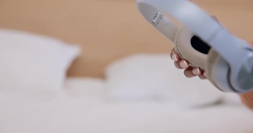 Woman Putting on Wireless Headphones Indoors