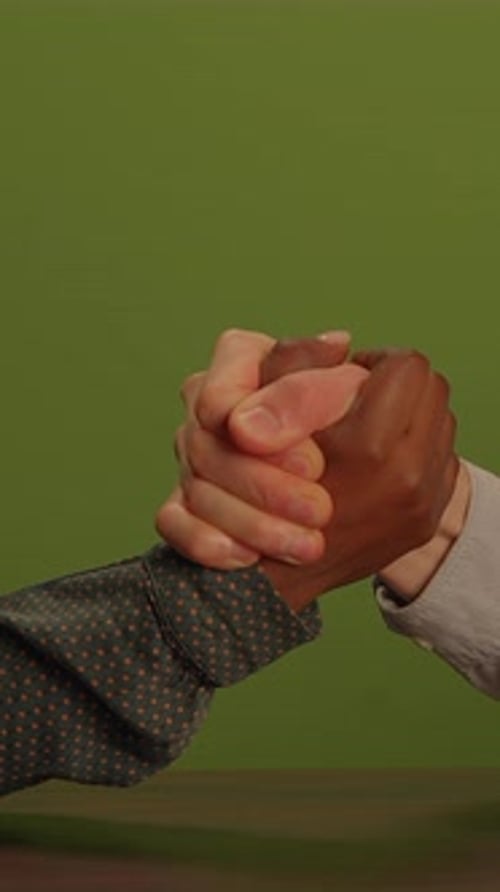 Close Up Arm Wrestling Match Against Green Screen