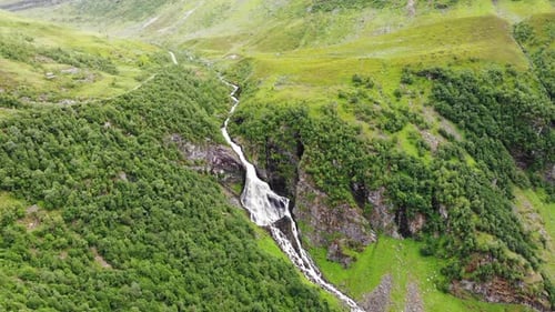 Waterfall In Green Mountains, Norway.