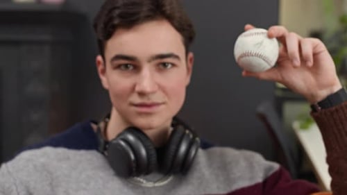 Portrait of Gen Z Guy Holding Baseball indoors