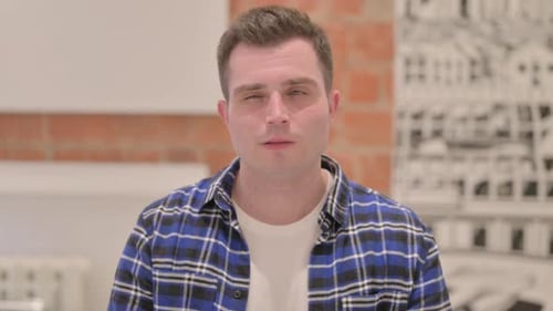 Portrait of Brainstorming Young Casual Man with New Idea