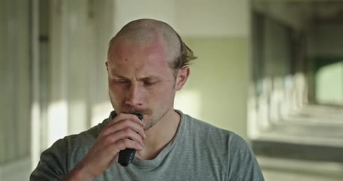 Unhappy Bald Man Shaving Mustache