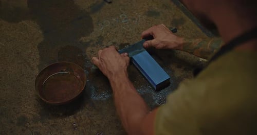 Medieval Craftsman is Sharpening Forged Steel Knife By Japanese Waterstone Closeup View Prores