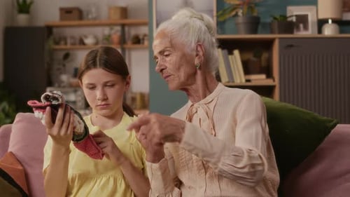 Girl Learning to Knit with Senior Woman at Home