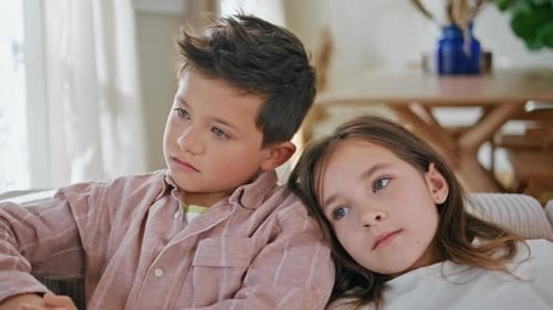 Closeup Bonding Siblings Relaxing at Cozy Couch Small Children Watching Cartoon