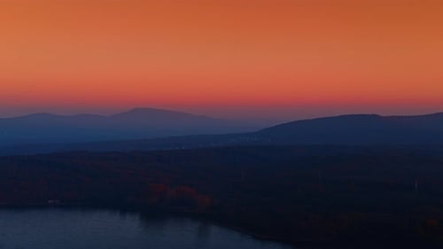 Colorful Sky over Mountains and Lake at Sunrise