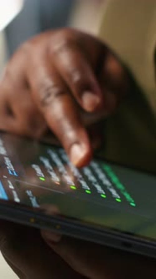 Vertical Video Close Up of Programmer Utilizing AI on Tablet to Optimize Performance